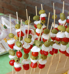 Caprese skewers with tomato mozzarella green olives and many san