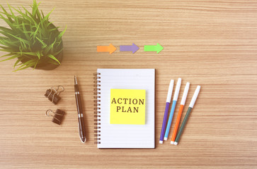 Action Plan text on sticky note, flat lay business office desk.