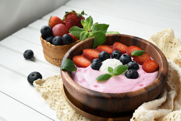 Ideas for healthy summer breakfast op dessert. Smoothies in bowls with strawberry, blueberry berry. With oatmeal, fresh berries.