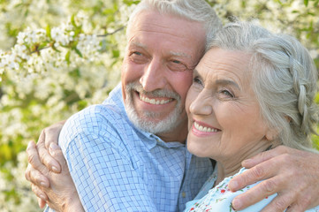 couple  hugging in  blooming garden 