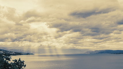 Sun rays over the sea, vintage filter