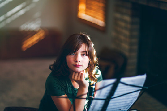 Girl daydreaming at clarinet practice