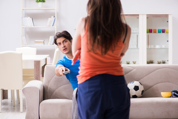 Wife unhappy that husband is watching football