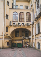 Fototapeta na wymiar The famous square courtyard with Waste containers and Air conditioners in Saint Petersburg, Russia.