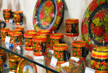 Khokhloma painting on tableware in the shop.