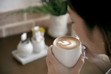 women drinking hot coffee latte.