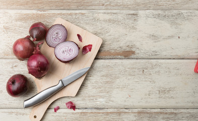 Red Onion Slices with wooden board on table wood,top view