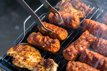 Close up pf delicious chicken breast on wooden skew with fresh vegetables, garlic, paprika fried on mangal barbeque grill