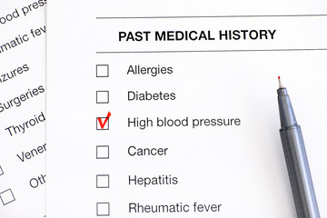 Past medical history questionary with ticked High Blood Pressure and pen.