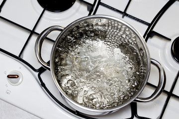 casserole with boiling water on the stove