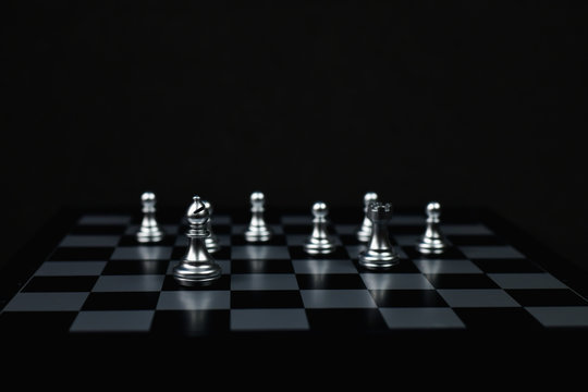 Leadership Concepts, Chess is a leader, Chess game on a black background.