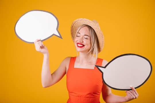 Happy Lovely Blonde Girl In Straw Hat And Red Fancy Dress Is Holding Speech Buble Banners. Yellow Background, Summer Conversation