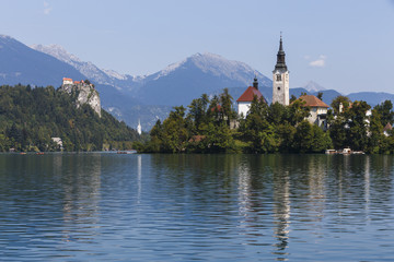 Fototapeta na wymiar Church on Island in Lake Bled, Slovenia, with Castle in distance