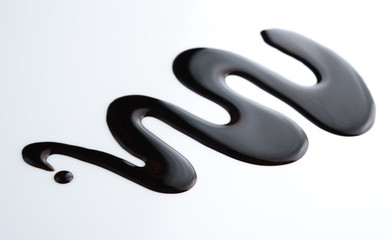 Spilled soy sauce isolated on white