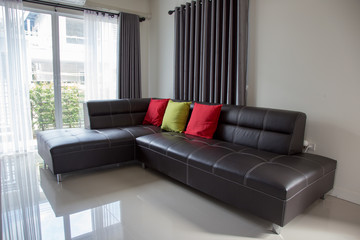 Fototapeta premium Black leather sofa and pillow in the house.