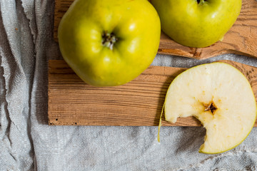 two yellow apple lying on a wooden table