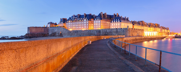 Night panoramic view of famous walled port city of Privateers Saint-Malo is known as city corsaire, Brittany, France