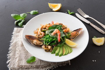 Warm salad with grilled seafood flat lay