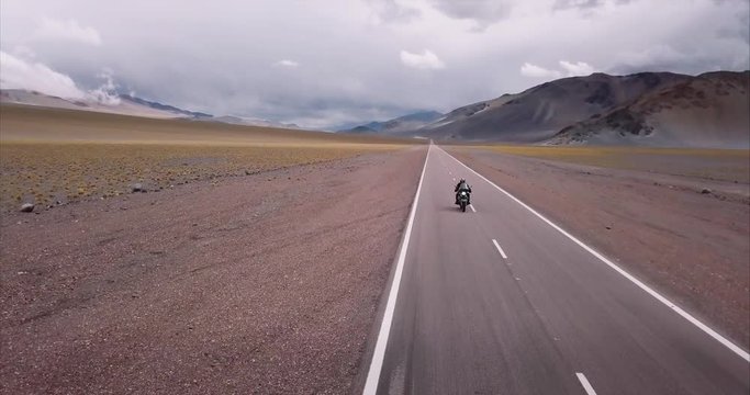 Aerial view of man in motorcycle adventure in the highway of the Andean mountain range. 4k