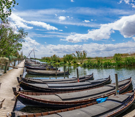 Albufera nature reserve with wooden fishing boats and pier in Catarroja, Valencia