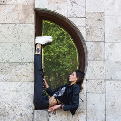 Girl street style urban hipster in the geometric city scene yoga gymnastics