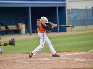 Baseball player swinging at the ball