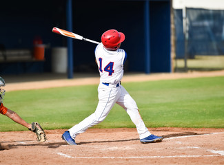 Baseball player swinging at the ball
