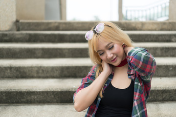 Asian hipsters girl posing for take a photo on the stair,lifestyle of modern woman,Thai people in hippie style,Happy woman concept