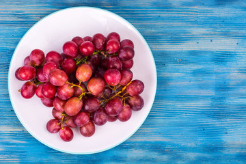 Plate with sweet, ripe red grapes