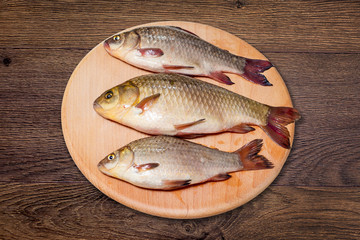 Fish, ready for cooking, on the kitchen board. Natural foods for healthy eating_