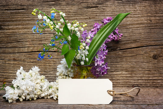 Greeting card with lilies of the valley, lilac and forget-me-not for Mother's Day