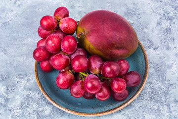 Mango and grapes on plate