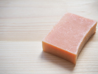 Soap economic on a wooden background. One piece handmade soap.