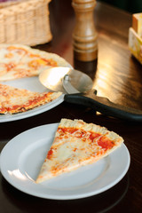 Pizza four cheese on white ceramic plate.