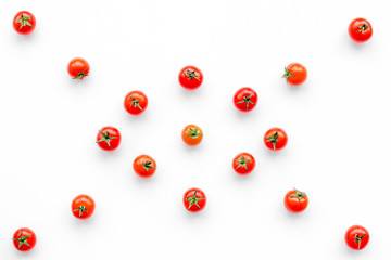 Fresh red tomatoes scattered on white background top view pattern