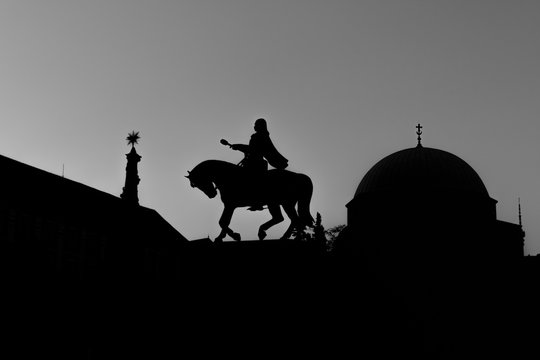 Silhouettes of 3 landmarks in Pecs, Hungary: the Holy Trinity Statue, the statue of Janos Hunyadi and the Mosque of Pasha Qasim