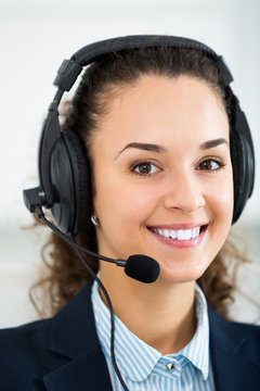 Woman professional operator talking with client by headset