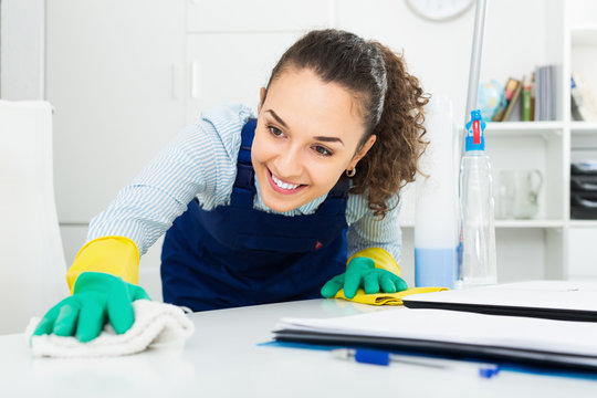 Young woman  doing clean-up in modern office