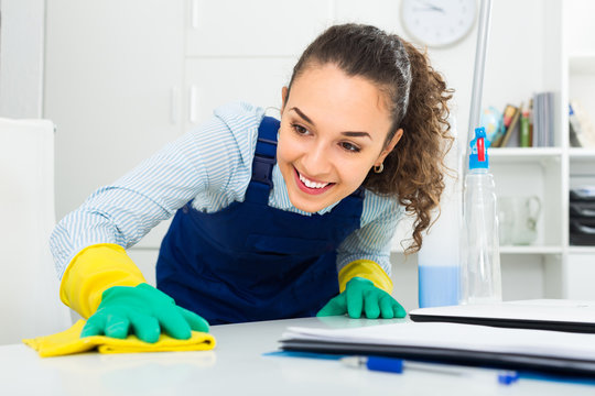 Female professional cleaner in office.
