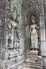Detail of the wall of the ancient Angkor Thom Bayon Temple in the Angkor Area, near Siem Reap, Cambodia, Asia. Buddhist monastery from the 12th century. Asian architectural background.