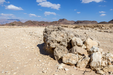 Volcanic bomb in geological Timna park, it is located 25 km north of Eilat (Israel), combines...