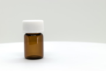 Three Brown Sample Bottle with White Cap on White Background with Free Space