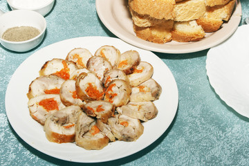 Sliced roll from chicken or turkey meat with vegetables filling. Cold snack for reception guests on festive table. Copy space