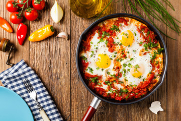 Shakshouka, dish of eggs poached in a sauce of tomatoes, chili peppers, onions