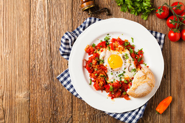 Shakshouka, dish of eggs poached in a sauce of tomatoes, chili peppers, onions