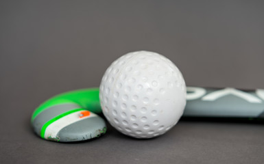 Hockey stick with ball on neutral background for sports clubs and teambuilding