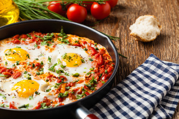 Shakshouka, dish of eggs poached in a sauce of tomatoes, chili peppers, onions