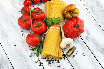 Italian food background with pasta, basil and tomato, health or vegetarian concept.