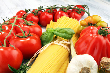 Italian food background with pasta, basil and tomato, health or vegetarian concept.