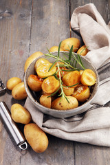 Roasted potato with fresh rosemary in a bowl
